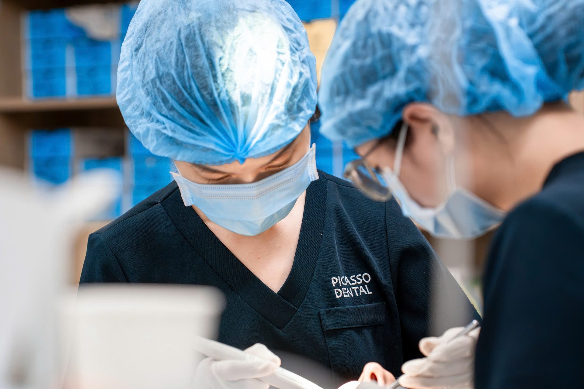 Dentist and nurse focused during emergency procedure at Picasso Dental